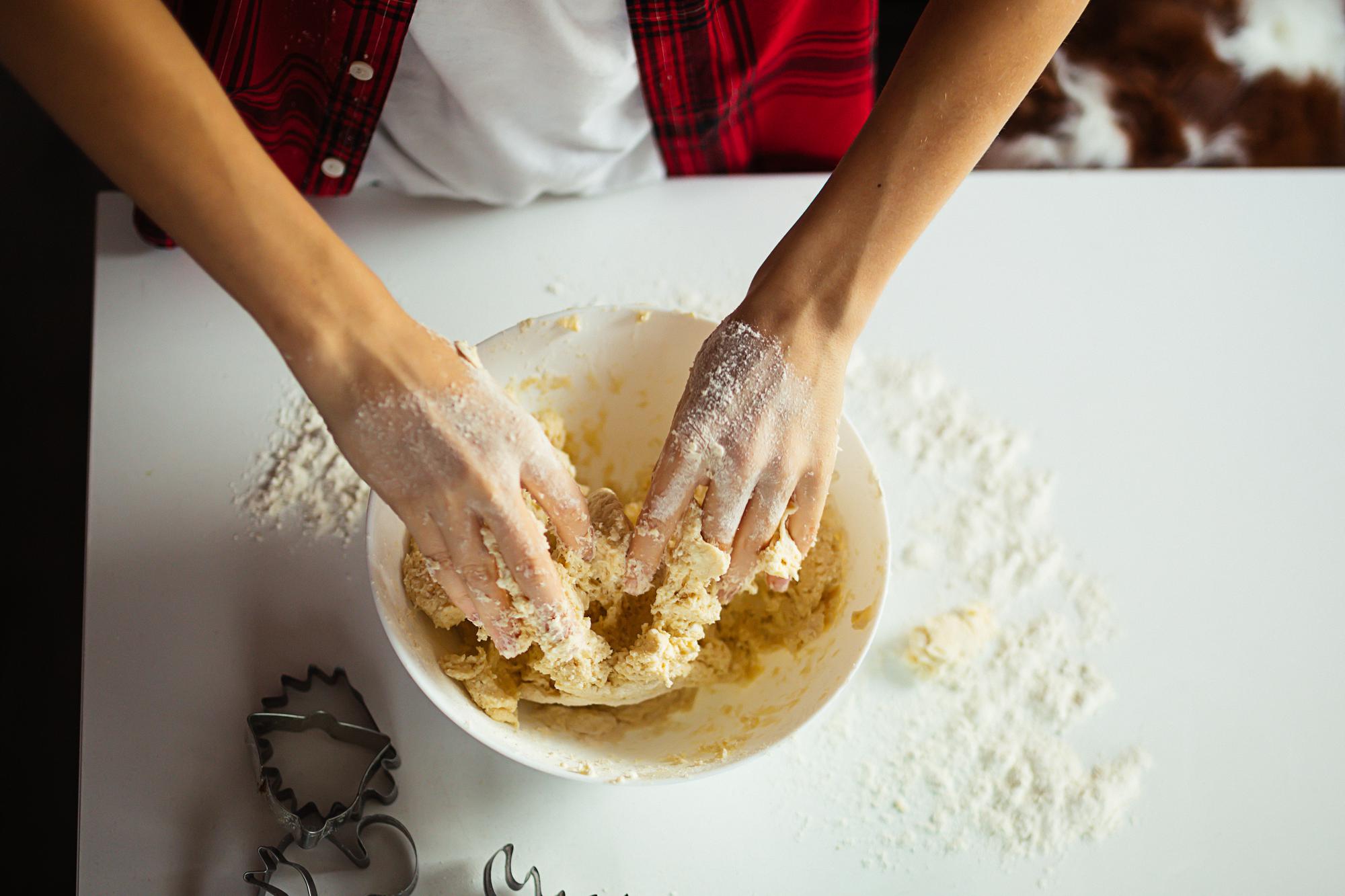 Detail of hands kneading dough